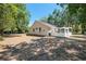 Wide view of the backyard showcasing a screened-in porch and ample outdoor space at 712 Harper Pl, Lady Lake, FL 32159