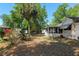 The property has a screened-in porch overlooking the backyard with mature trees and greenery at 712 Harper Pl, Lady Lake, FL 32159