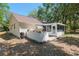 The backyard features a screened-in patio and lush landscaping, perfect for outdoor living at 712 Harper Pl, Lady Lake, FL 32159
