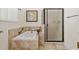 Bathroom showcases a soaking tub and glass enclosed shower with neutral tile surround at 712 Harper Pl, Lady Lake, FL 32159