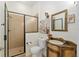 Bathroom featuring a vanity with stone sink, framed mirror, and glass enclosed shower at 712 Harper Pl, Lady Lake, FL 32159