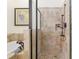 Bathroom showcases a soaking tub and glass enclosed shower with neutral tile surround at 712 Harper Pl, Lady Lake, FL 32159
