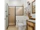 Bathroom featuring a vanity with stone sink, framed mirror, and glass enclosed shower at 712 Harper Pl, Lady Lake, FL 32159