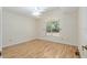 Light filled bedroom with wood look vinyl flooring and arched window at 712 Harper Pl, Lady Lake, FL 32159