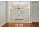Bright foyer featuring double entry doors, tiled flooring, and views into the adjacent living spaces at 712 Harper Pl, Lady Lake, FL 32159