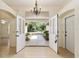Welcoming foyer with double glass doors and neutral tile flooring leading to a lush backyard view at 712 Harper Pl, Lady Lake, FL 32159