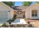 Inviting home exterior with a walkway leading to the double front doors and a well-maintained lawn at 712 Harper Pl, Lady Lake, FL 32159