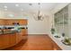 Well-lit kitchen featuring granite countertops, a functional island, and views into the living and dining areas at 712 Harper Pl, Lady Lake, FL 32159