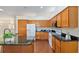 Spacious kitchen with stainless steel appliances, granite counters, and wood cabinets at 712 Harper Pl, Lady Lake, FL 32159