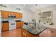 Bright kitchen with a view to dining area, featuring granite counters and black faucet at 712 Harper Pl, Lady Lake, FL 32159