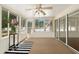 Inviting sunroom with ample natural light, ceiling fan, sliding glass doors and neutral carpet at 712 Harper Pl, Lady Lake, FL 32159