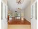 Spacious living room featuring shiny hardwood floors, ceiling fans, and an inviting view towards the backyard at 712 Harper Pl, Lady Lake, FL 32159