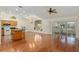 Spacious layout with hardwood floors, leading to kitchen with an island and screened lanai with sliding glass doors at 712 Harper Pl, Lady Lake, FL 32159