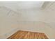Spacious walk-in closet with built-in wire shelving and wood look vinyl flooring at 712 Harper Pl, Lady Lake, FL 32159