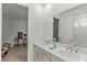 Bright bathroom featuring a double vanity with white countertops, dual sinks, and modern fixtures at 7687 Sw 63Rd Place Rd, Ocala, FL 34474