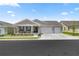 Charming single-story home with a three-car garage, inviting front porch, and beautifully landscaped front yard at 7687 Sw 63Rd Place Rd, Ocala, FL 34474