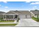Charming single-story home featuring a covered porch, two-car garage, and well-maintained landscaping at 7687 Sw 63Rd Place Rd, Ocala, FL 34474