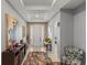 Elegant foyer featuring tile floors, a neutral palette, and decorative furnishings, leading into the living space at 7687 Sw 63Rd Place Rd, Ocala, FL 34474