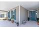 Inviting front porch with blue front door, bench, nice plants and blue shutters provide a perfect curb appeal at 7687 Sw 63Rd Place Rd, Ocala, FL 34474