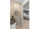 Hallway featuring a decorative mirror and access to a bedroom in the background at 7687 Sw 63Rd Place Rd, Ocala, FL 34474