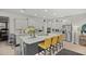Spacious kitchen with gray cabinetry, stainless appliances, a marble island and modern lighting at 7687 Sw 63Rd Place Rd, Ocala, FL 34474