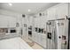 Bright and spacious kitchen with white cabinetry, stainless steel appliances, and a center island at 7687 Sw 63Rd Place Rd, Ocala, FL 34474