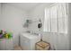 Bright laundry room with full-size washer and dryer, shelving, and ample natural light at 7687 Sw 63Rd Place Rd, Ocala, FL 34474