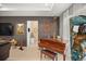 Living room featuring a baby grand piano, art, and other decor at 7687 Sw 63Rd Place Rd, Ocala, FL 34474