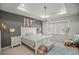 Well-lit main bedroom with a tray ceiling, ceiling fan, king-sized bed and access to the backyard at 7687 Sw 63Rd Place Rd, Ocala, FL 34474