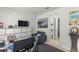 Contemporary office area with TV, desk, chair, and adjacent doorway to a bathroom at 7687 Sw 63Rd Place Rd, Ocala, FL 34474