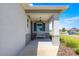 Inviting covered front porch features a comfortable bench, stylish shutters, and a charming light fixture at 7696 Sw 86Th Ct, Ocala, FL 34481