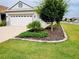 Manicured front yard featuring lush landscaping and a well-maintained lawn complementing the home's curb appeal at 7696 Sw 86Th Ct, Ocala, FL 34481