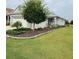 Charming one-story home featuring a manicured lawn and beautiful landscaping with stone accents at 7696 Sw 86Th Ct, Ocala, FL 34481