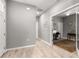 Hallway shows wood-look tile flooring and doors to office, bedrooms and bathrooms at 7696 Sw 86Th Ct, Ocala, FL 34481