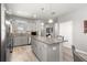 Well-lit kitchen with granite countertops, gray cabinets, and stainless steel appliances at 7696 Sw 86Th Ct, Ocala, FL 34481