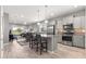Modern kitchen with gray cabinets, stainless steel appliances, and an island with bar seating at 7696 Sw 86Th Ct, Ocala, FL 34481