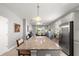 Open kitchen with granite countertops, stainless steel appliances, and a view of the living area at 7696 Sw 86Th Ct, Ocala, FL 34481