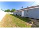 A large backyard with a privacy fence and access door, offering ample space for outdoor activities at 8004 Juniper Rd, Ocala, FL 34480