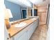 Well-lit bathroom features a double sink vanity with neutral counters and a tiled walk-in shower at 8004 Juniper Rd, Ocala, FL 34480