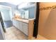 View of a bathroom featuring double sinks, and a shower with elegant tile accents at 8004 Juniper Rd, Ocala, FL 34480