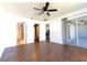 Bedroom with hardwood floors, ceiling fan, walk-in closet, and access to a private lanai at 8004 Juniper Rd, Ocala, FL 34480