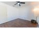 Cozy bedroom features modern ceiling fan and dark wood-look flooring at 8004 Juniper Rd, Ocala, FL 34480