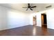 Bedroom features hardwood floors, ceiling fan, ensuite bathroom, and walk-in closet at 8004 Juniper Rd, Ocala, FL 34480