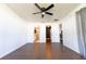 Bedroom featuring hardwood floors, ceiling fan, and ensuite bathroom at 8004 Juniper Rd, Ocala, FL 34480