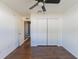 Bedroom features closet and door with dark wood-look flooring at 8004 Juniper Rd, Ocala, FL 34480