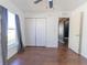 Bedroom featuring a window, ceiling fan, wood floors, closet and doorway at 8004 Juniper Rd, Ocala, FL 34480