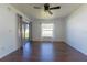 Bright bedroom with hardwood floors, neutral walls, and access to a private patio at 8004 Juniper Rd, Ocala, FL 34480