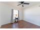 Bedroom features a window, curtains, and table with dark wood-look flooring at 8004 Juniper Rd, Ocala, FL 34480