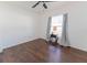 Bedroom features a window, curtains, and table with dark wood-look flooring at 8004 Juniper Rd, Ocala, FL 34480