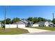 The house features a large driveway and two car garage, surrounded by a well maintained lawn at 8004 Juniper Rd, Ocala, FL 34480